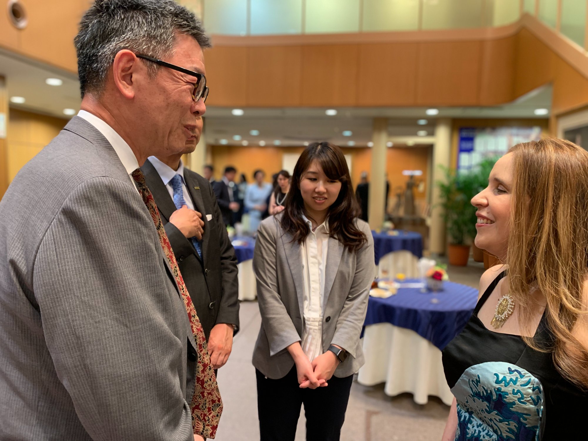 People in conversation during a cultural exchange gathering in Japan