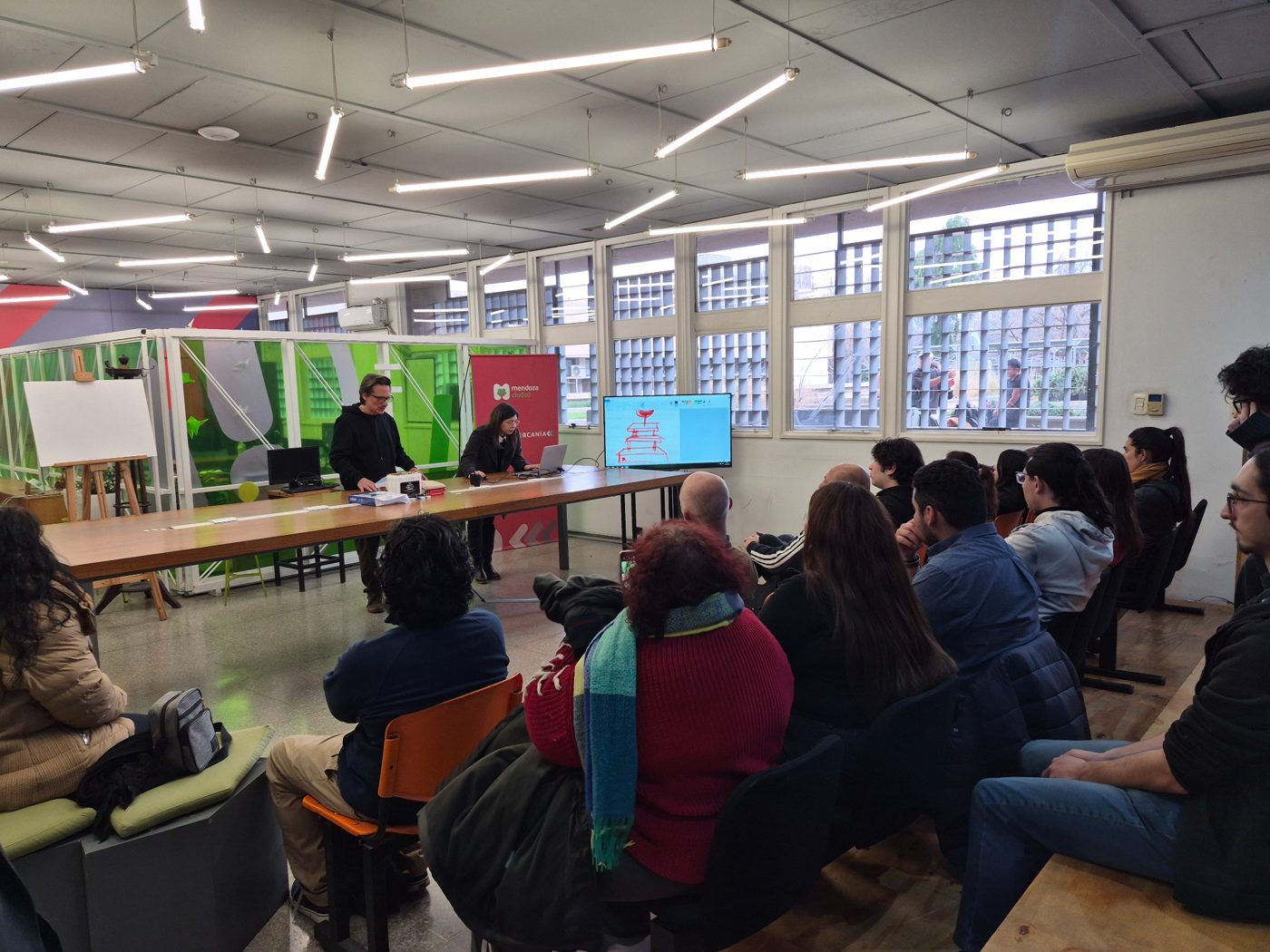 A group gathered for a conversation and presentation